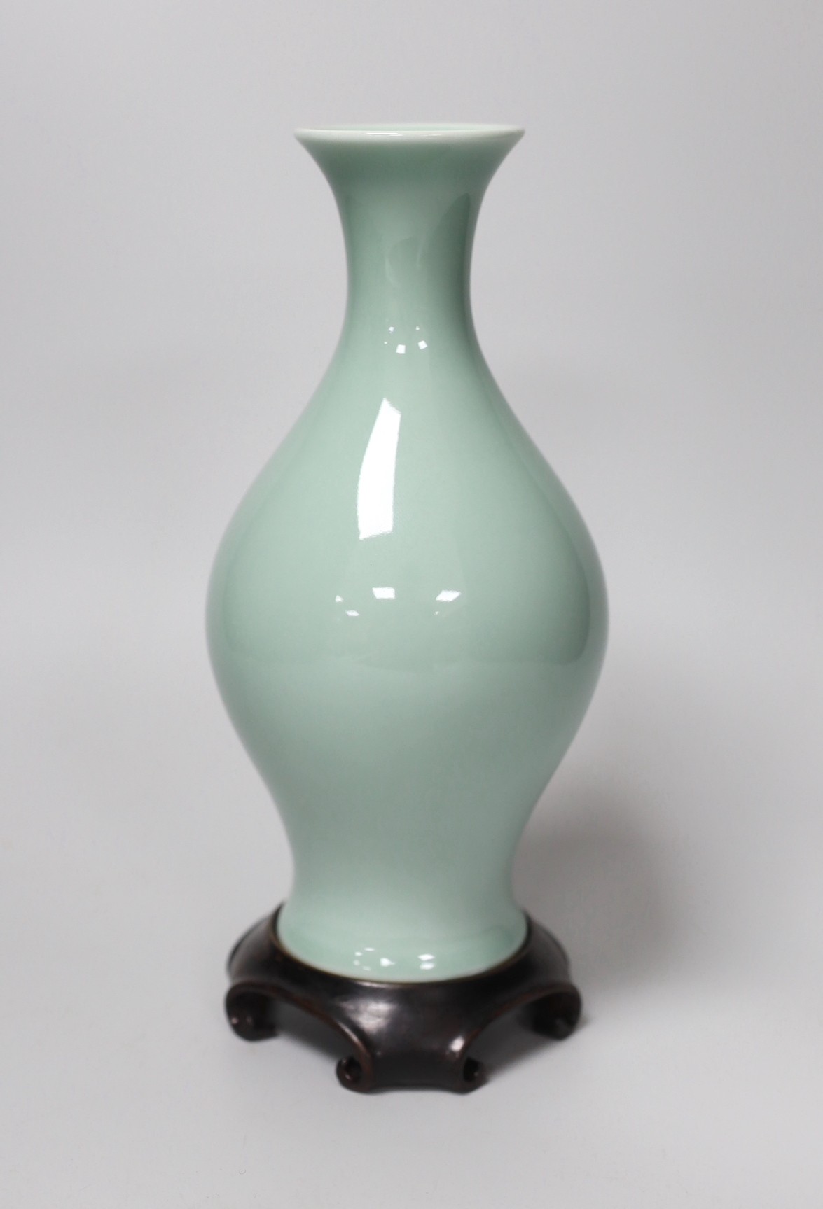A Chinese celadon glazed vase, hallmark to base, wood stand. 24.5cm high